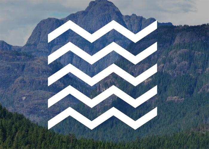 White mountain pattern over photo of mountain. 